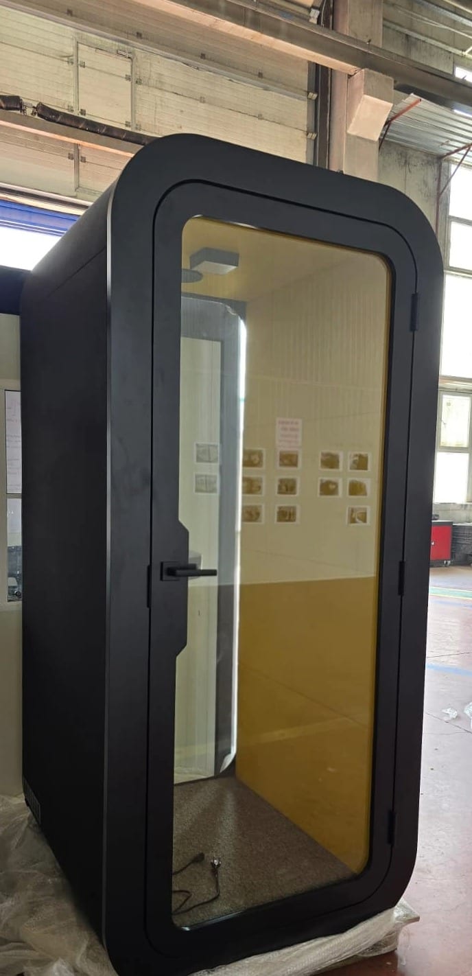 Black phone booth unwrapped and ready, yellow interior